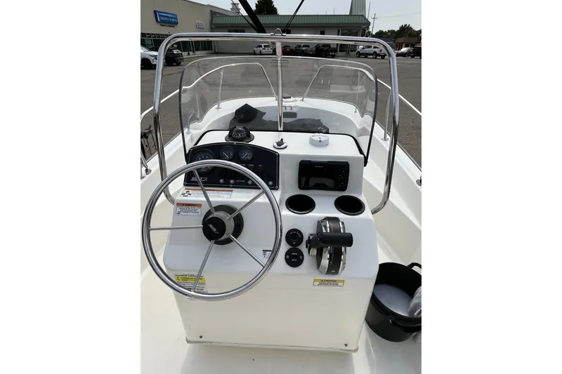 Slide: The Image of 2017 Boston Whaler 170 Montauk boat console with steering wheel and controls. - 16