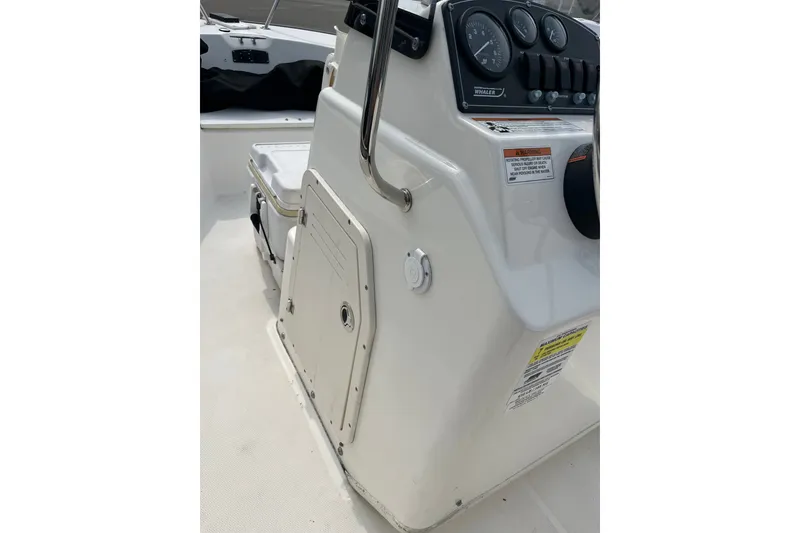 Slide: The Image of 2017 Boston Whaler 170 Montauk boat console with gauges and storage compartment. - 15