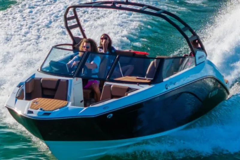 Slide: The Image of 2026 Yamaha Boats 222SE cruising on water with passengers enjoying the ride. - 2
