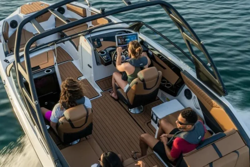 Slide: The Image of 2026 Yamaha Boats 222SE cruising with passengers on a sunny day. - 6