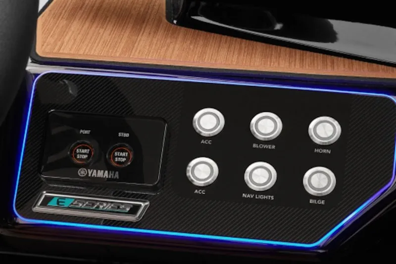Slide: The Image of Dashboard of 2026 Yamaha Boats 222XE with control buttons and wood finish. - 9