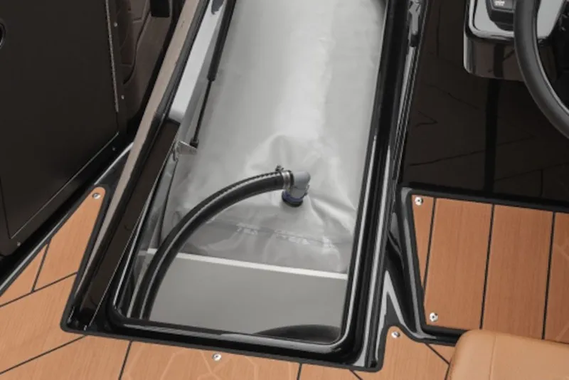 Slide: The Image of 2026 Yamaha Boats 222XE storage compartment with hose on teak-style deck. - 7