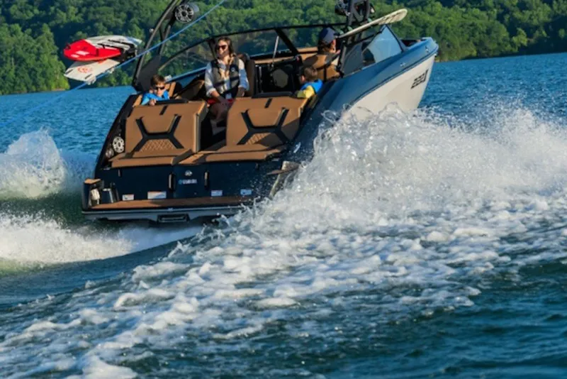Slide: The Image of 2026 Yamaha Boats 222XE cruising on a scenic lake with passengers enjoying the ride. - 11