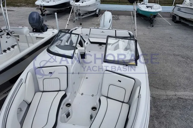 Slide: The Image of The image shows a modern Stingray 22DC boat with white interior and black accents. - 4