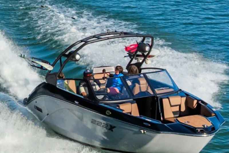 Slide: The Image of 2027 Yamaha Boats 222XD cruising on open water with passengers enjoying the ride. - 2