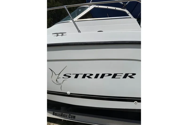 Slide: The Image of 1999 Seaswirl Striper 2301 Walkaround OB boat side view with logo. - 2