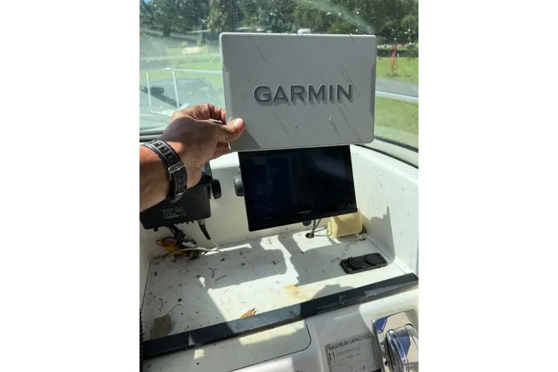 Slide: The Image of 1999 Seaswirl Striper 2301 Walkaround OB dashboard with Garmin navigation system. - 4