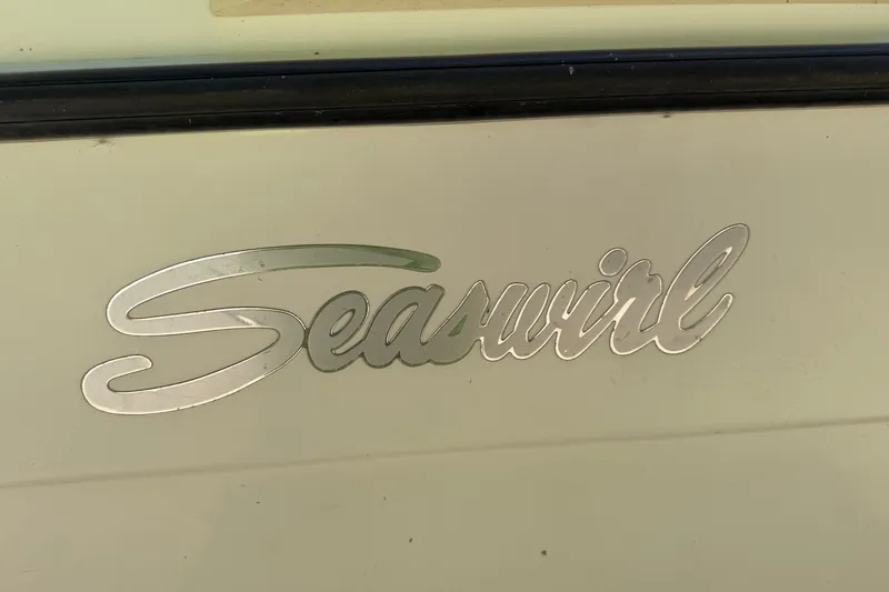 Slide: The Image of Seaswirl logo on 1999 Striper 2301 Walkaround OB boat exterior. - 7