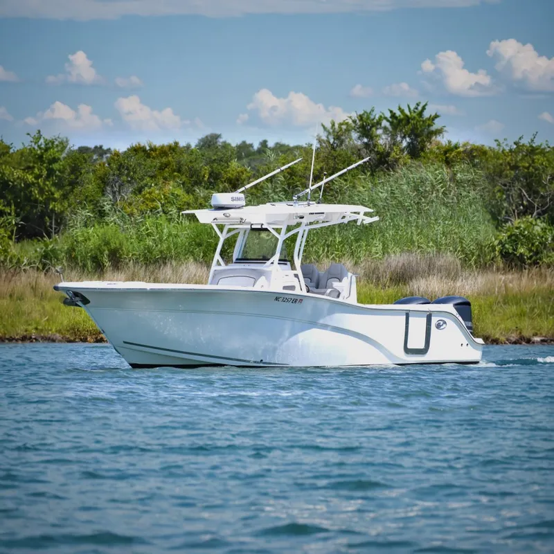 The Image of 2020 Sea Fox 288 Commander boat on water, surrounded by lush greenery. - 0