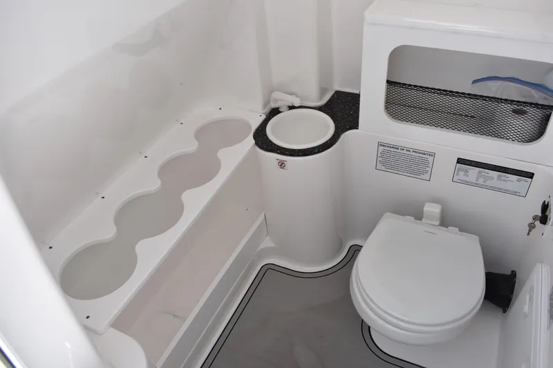 Slide: The Image of 2020 Sea Fox 288 Commander boat bathroom with toilet and storage compartments. - 30