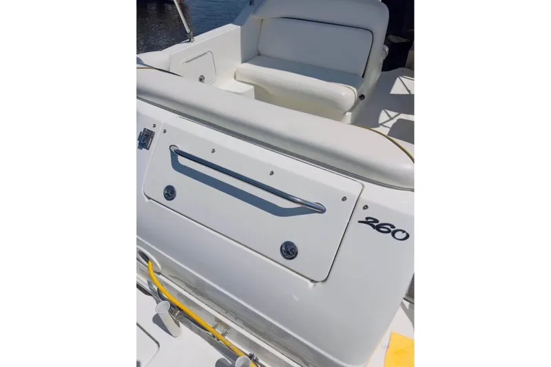 Slide: The Image of 2003 Sea Ray Sundancer 260 boat interior with seating and storage compartment. - 4