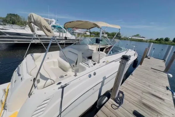 Slide: The Image of 2003 Sea Ray Sundancer 260 docked at marina under clear blue sky. - 2