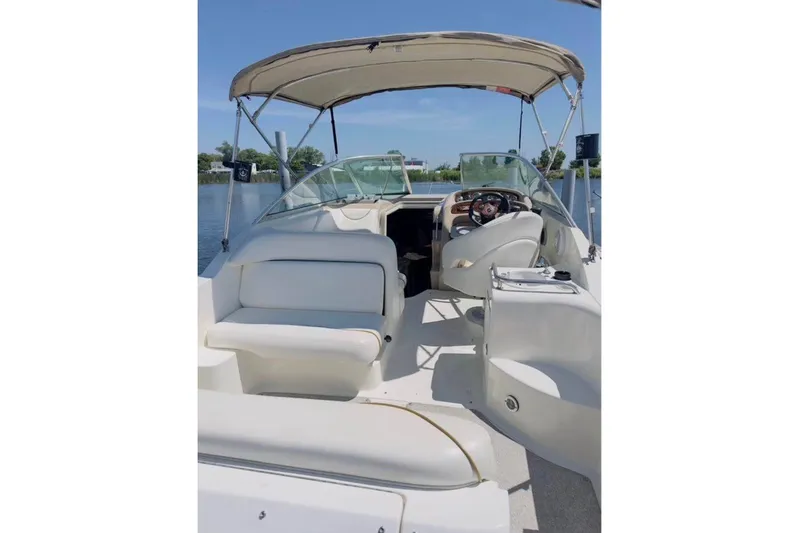Slide: The Image of 2003 Sea Ray Sundancer 260 boat interior with seating and steering wheel under canopy. - 3