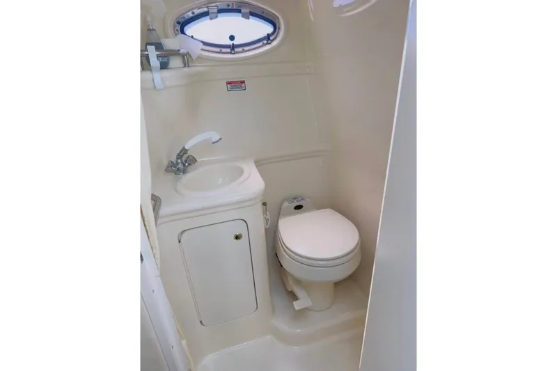 Slide: The Image of Compact bathroom in 2003 Sea Ray Sundancer 260 boat with sink and toilet. - 7