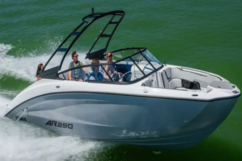Slide: The Image of 2027 Yamaha Boats AR250 speeding on green water with passengers enjoying the ride. - 9