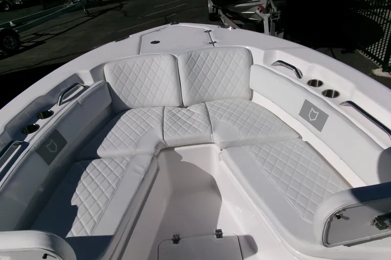 Slide: The Image of 2026 Sea Fox 248 Commander boat interior with white cushioned seating and cup holders. - 7