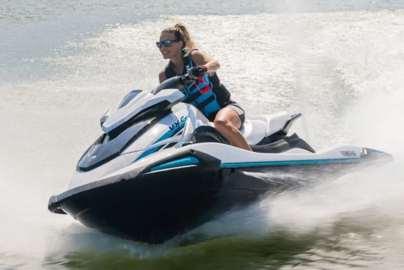 Slide: The Image of Person riding 2027 Yamaha Boats VX-C jet ski on water, creating splash. - 2