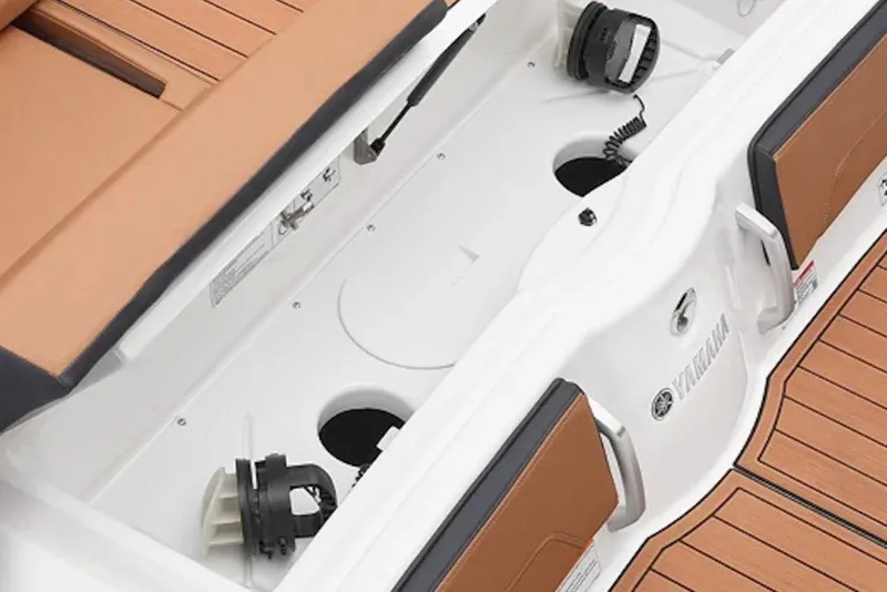 Slide: The Image of 2026 Yamaha Boats 252SD interior storage compartment with tan seating and teak-style flooring. - 3
