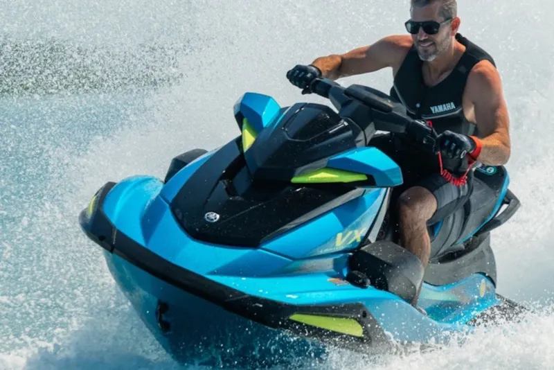 Slide: The Image of 2027 Yamaha WaveRunner VX Limited jet ski on water, rider enjoying speed. - 5