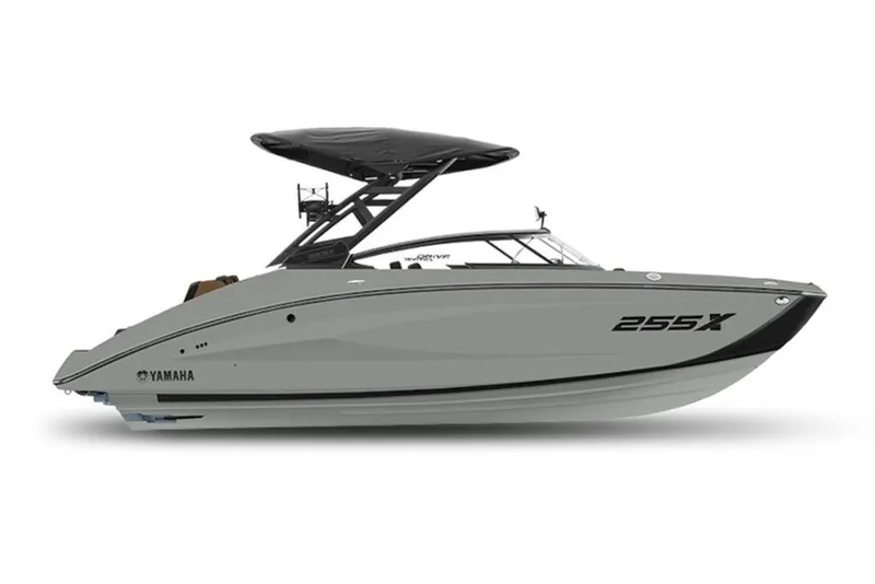 Slide: The Image of 2027 Yamaha Boats 255XD, sleek design, gray hull, black canopy, side view. - 2