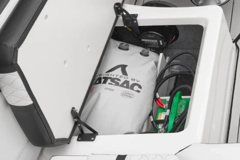 Slide: The Image of Open storage compartment in 2027 Yamaha Boats 255XD, featuring ballast bag and wiring. - 4