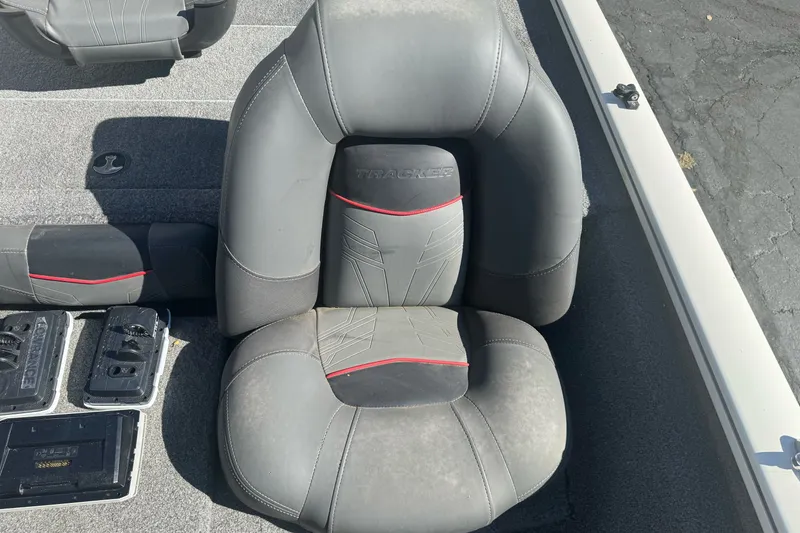 Slide: The Image of 2022 Tracker Pro Team 190 TX boat seat with gray upholstery and red accents. - 15