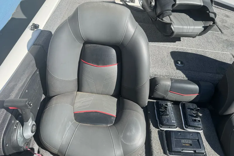 Slide: The Image of 2022 Tracker Pro Team 190 TX boat interior with gray seats and control panel. - 16