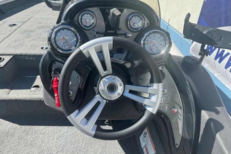 Slide: The Image of 2022 Tracker Pro Team 190 TX boat dashboard with steering wheel and gauges. - 17