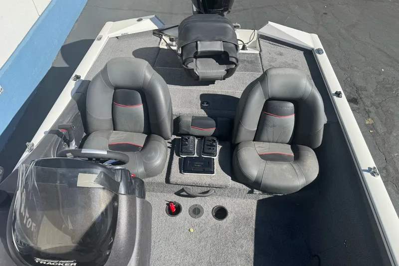 Slide: The Image of 2022 Tracker Pro Team 190 TX boat interior with gray seating and steering console. - 14
