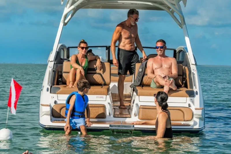 Slide: The Image of People enjoying a day on a 2027 Yamaha Boats 275SD in the ocean. - 2