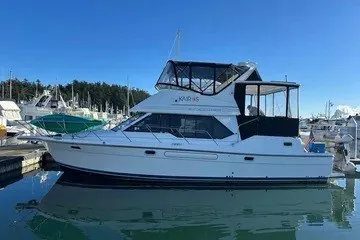 Slide: The Image of 2000 Bayliner 4087 Aft Cabin Motoryacht docked at marina under clear blue sky. - 53