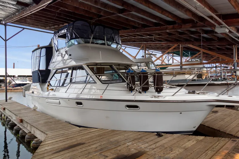 Slide: The Image of 2000 Bayliner 4087 Aft Cabin Motoryacht docked in a covered marina. - 52