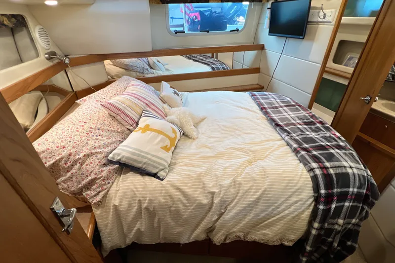 Slide: The Image of Cozy bedroom in 2000 Bayliner 4087 Aft Cabin Motoryacht with plush bedding and nautical decor. - 21