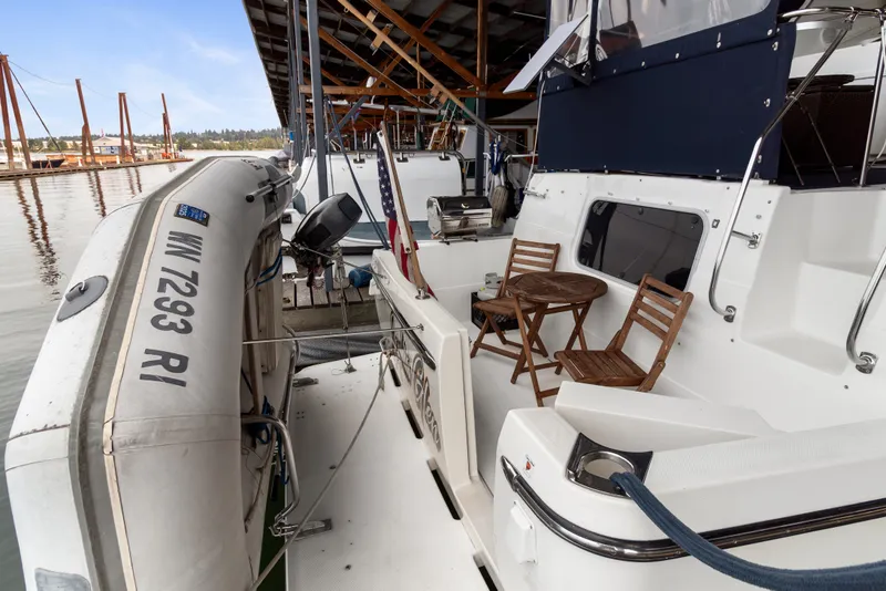 Slide: The Image of Bayliner 4087 Aft Cabin Motoryacht 2000 with dinghy and seating area in marina. - 47