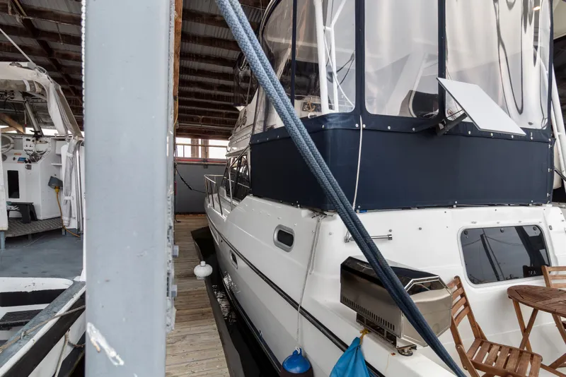 Slide: The Image of 2000 Bayliner 4087 Aft Cabin Motoryacht docked in a covered marina. - 44