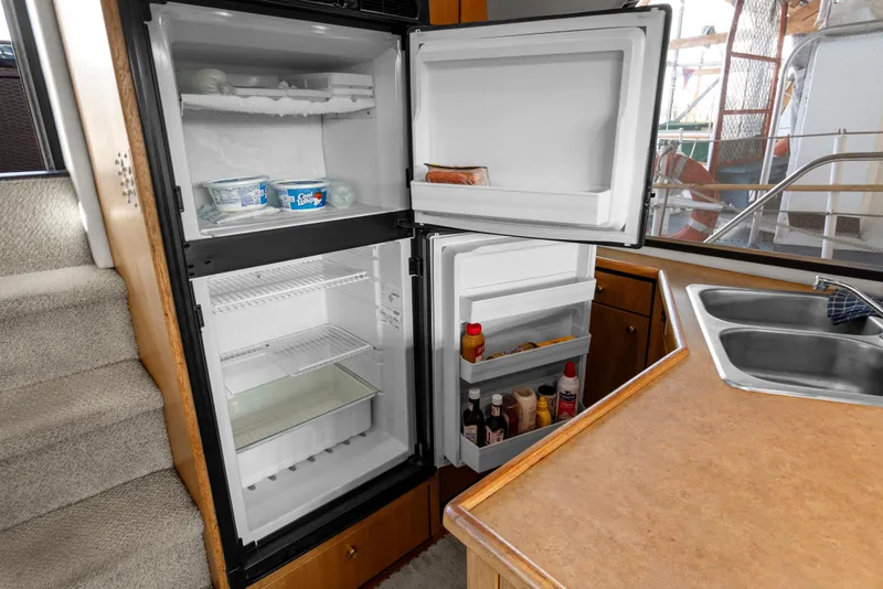 Slide: The Image of Open refrigerator in 2000 Bayliner 4087 Aft Cabin Motoryacht kitchen, stocked with condiments and Cool Whip. - 17