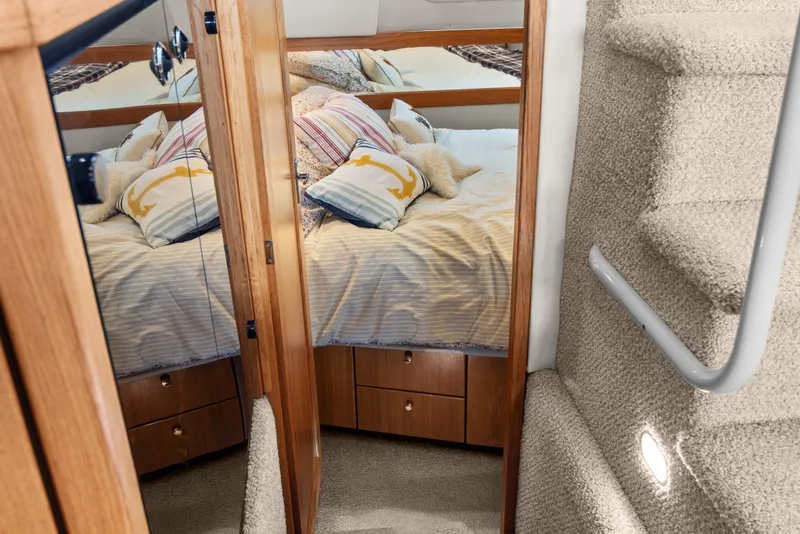 Slide: The Image of Cozy bedroom in 2000 Bayliner 4087 Aft Cabin Motoryacht with mirrored closet and carpeted stairs. - 20