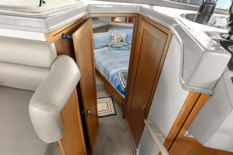 Slide: The Image of 2000 Bayliner 4087 Aft Cabin Motoryacht interior with cozy bedroom and wooden doors. - 26