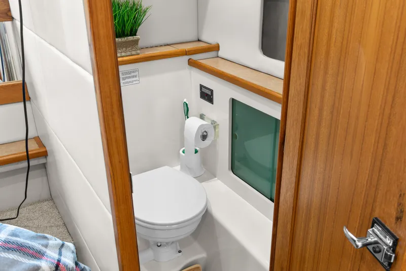 Slide: The Image of Bayliner 4087 Aft Cabin Motoryacht 2000 bathroom with wooden accents and modern fixtures. - 24
