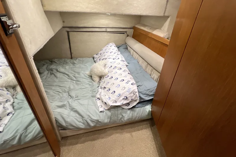 Slide: The Image of Cozy cabin bedroom in 2000 Bayliner 4087 Aft Cabin Motoryacht with nautical-themed bedding. - 29