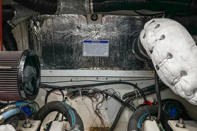 Slide: The Image of Engine room of 2000 Bayliner 4087 Aft Cabin Motoryacht with visible components and wiring. - 48