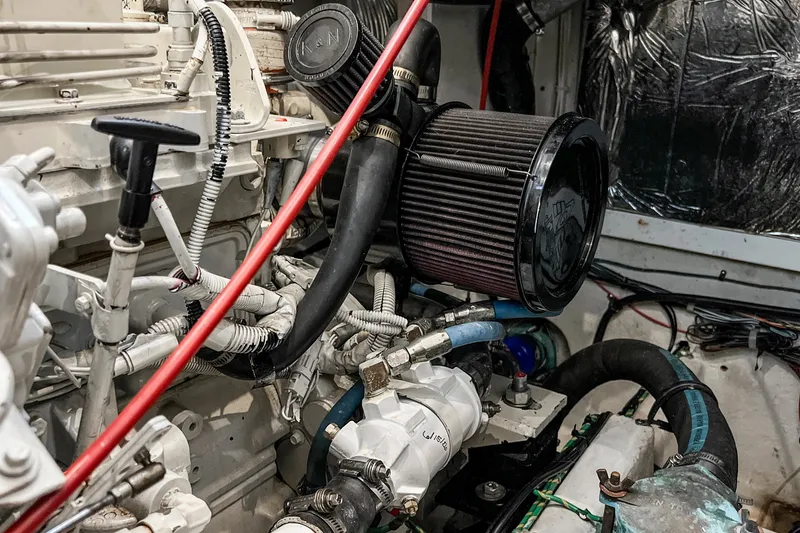 Slide: The Image of Engine room of 2000 Bayliner 4087 Aft Cabin Motoryacht with visible air filter and hoses. - 49