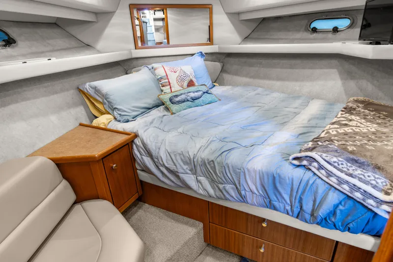 Slide: The Image of Cozy bedroom in 2000 Bayliner 4087 Aft Cabin Motoryacht with plush bedding and wooden cabinetry. - 28