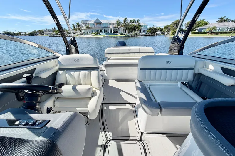Slide: The Image of Interior of a 2020 Cobalt 23SC boat with luxurious seating and waterfront view. - 13