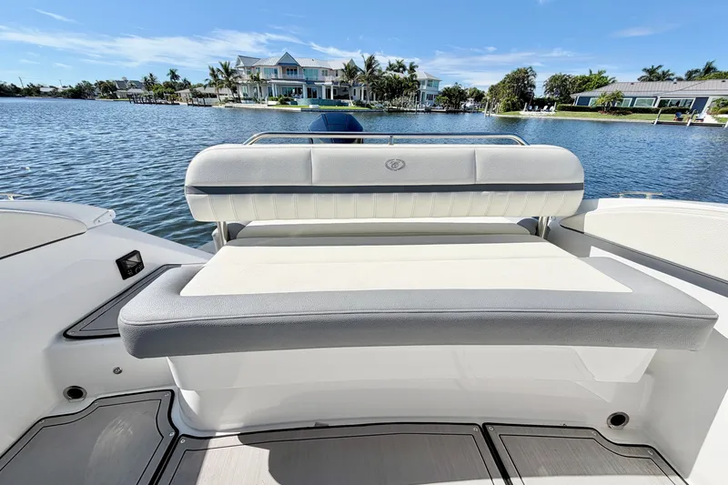Slide: The Image of 2020 Cobalt 23SC boat with luxurious seating, overlooking serene waterfront homes. - 11