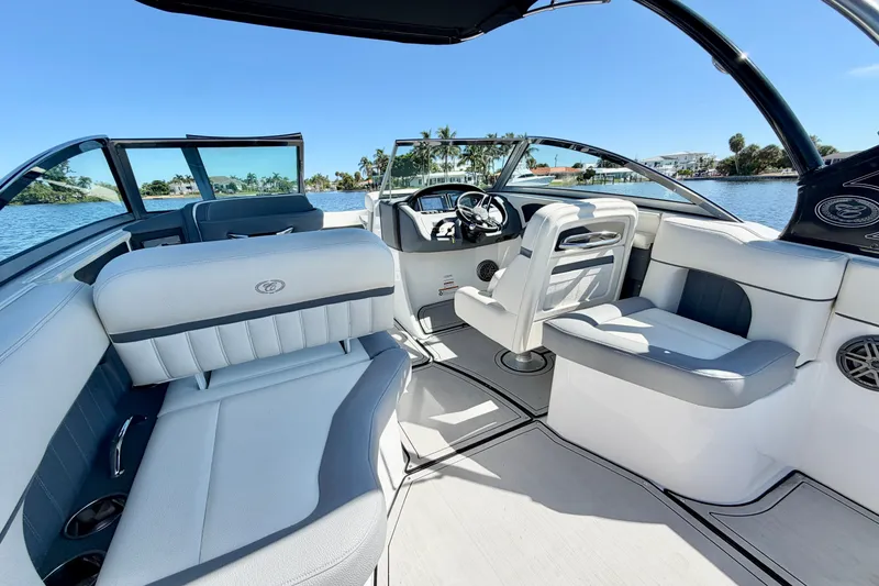 Slide: The Image of 2020 Cobalt 23SC boat interior with luxurious seating and modern design on a sunny day. - 14