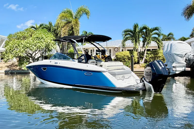 Slide: The Image of 2020 Cobalt 23SC boat on water, surrounded by palm trees and clear blue sky. - 4