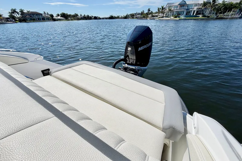 Slide: The Image of 2020 Cobalt 23SC boat with Mercury engine on a serene lake. - 6