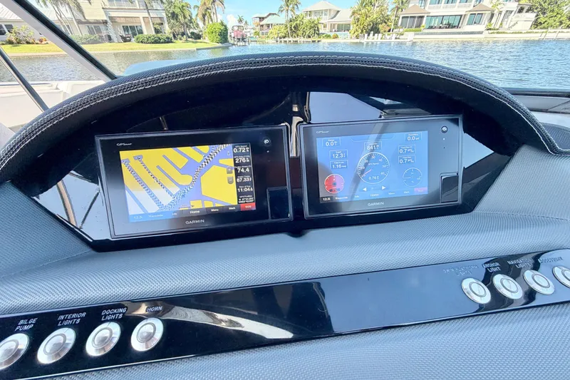 Slide: The Image of Dashboard of a 2020 Cobalt 23SC boat with Garmin navigation displays. - 19