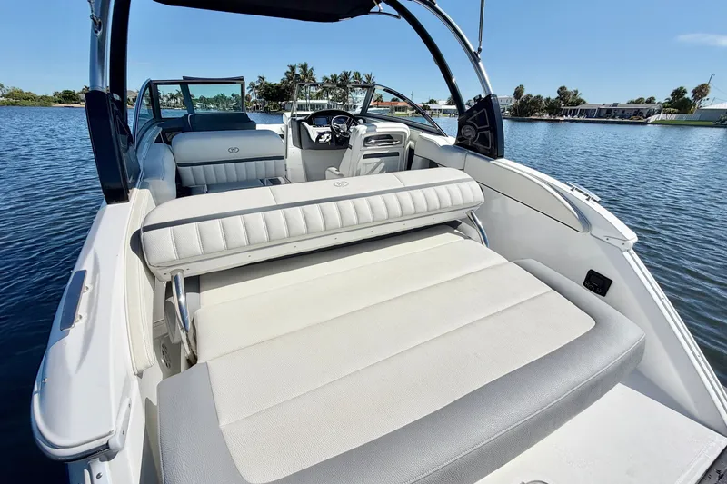 Slide: The Image of 2020 Cobalt 23SC boat with luxurious seating on a serene lake. - 7